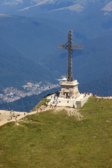 Bucegi Mountains, ROMANIA - AUGUST 14, 2016: Heroes' Cross on Caraiman Peak. The Heroes' Cross is a monument built between 1926 and 1928 on Caraiman Peak at an altitude of 2,291 m. 
