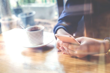 woman using on mobile phone during rest in coffee shop