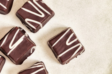 Small chocolate cakes (mignon) with cream. Top view with copy space