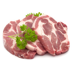 Raw pork neck chop meat with parsley herb leaves garnish isolated on white background cutout