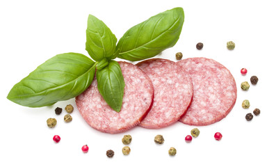 Salami smoked sausage three slices, basil leaves and peppercorns isolated on white background cutout