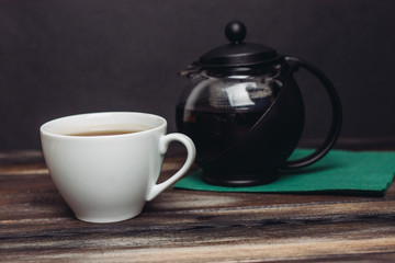 kettle and a white mug with a drink