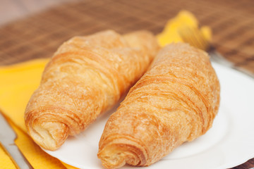 croissants on a plate and yellow napkins...