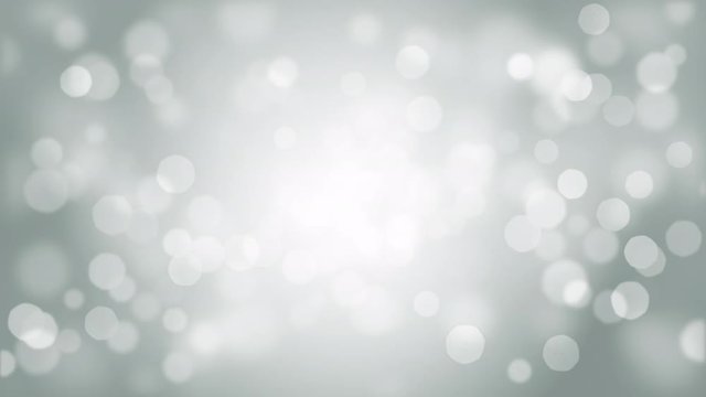 Abstract seamless looping footage of glowing particles moving against gray background
