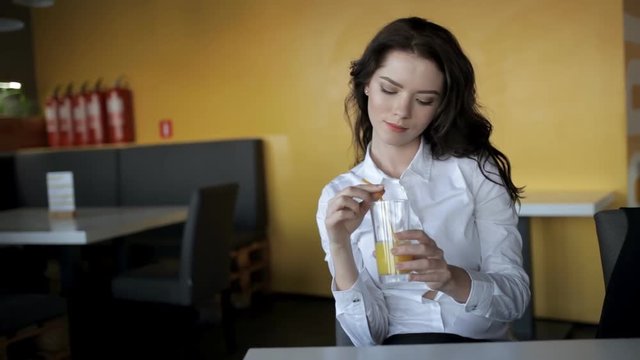 Young woman drinking fresh juice in cafe