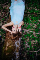Fototapeta premium outdoor portrait of a beautiful brunette model in blue dress in the spring forest
