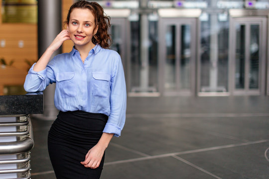 Business girl standing in office building and looking forward