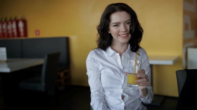 Funny woman clink glasses with fresh juice in cafe