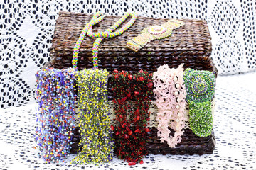 Straw basket with women's jewelry. Multicolored necklaces made of beads