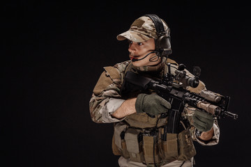 Portrait soldier or private military contractor holding sniper rifle. war, army, weapon, technology...