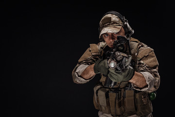 Portrait soldier or private military contractor holding sniper rifle. war, army, weapon, technology and people concept. Image on a black background.