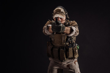 Portrait soldier or private military contractor holding sniper rifle. war, army, weapon, technology and people concept. Image on a black background.