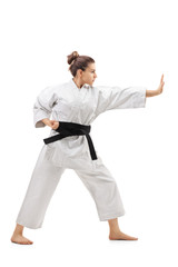 Young woman in a kimono practicing karate
