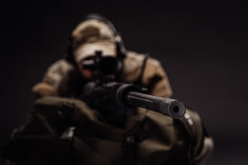military contracto with his sniper rifle at night. war, army, weapon, technology and people concept
