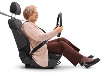 Mature woman in a car seat holding a steering wheel