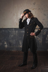 Fototapeta na wymiar Handsome male in a hat-cylinder, Steam punk style. Retro man portrait over grunge background.