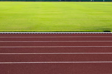 Stof per meter red running track and green grass in stadium © bennnn