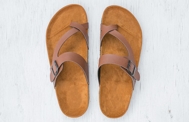 Men's sandals top view on rustic wood background.