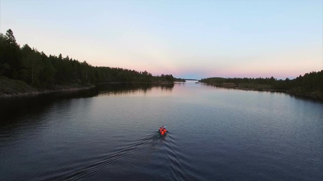 Unrecognizable people in boat at evening aerial shot