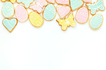 Background with homemade colorful easter biscuits isolated on white.
