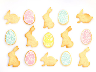Pattern with homemade Easter cookies on white background. Top view, Easter card.