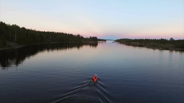 Unrecognizable people in boat at evening aerial shot
