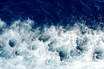 Fototapeta na wymiar Blue sea waves with a lot of sea foam
