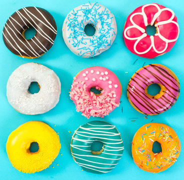 Various colorful donuts on blue background.