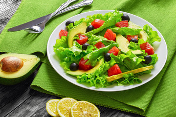 salad of  lettuce, avocado, chunks of salted salmon