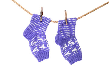 Beautiful knitted socks with an ornament hanging on a rope