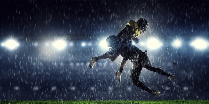 American football players at arena . Mixed media