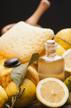 lemon essential oil and lemon fruit on the wooden board