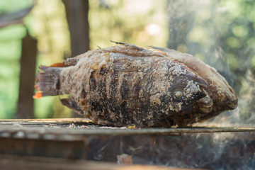 Hot fish on a grilling pan,grilled fish on the grill closeup