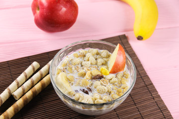 Fruit muesli in a bowl with apple and banana