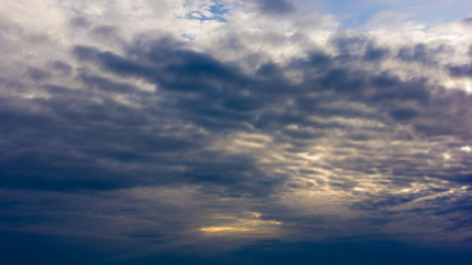 Beautiful cloudy sky with sun rays. Dramatic sky with stormy clouds