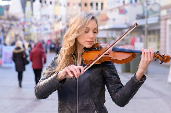 Woman playing violin in the street