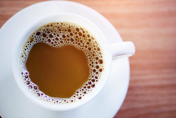top view of a hot cup of coffee put on a desktop background