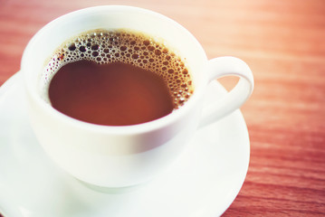 top view of a hot cup of coffee put on a desktop background