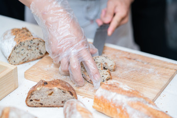 chef slicing bread in th kitchen