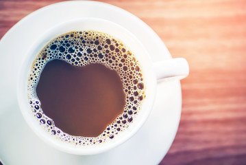 top view of a hot cup of coffee put on a desktop background