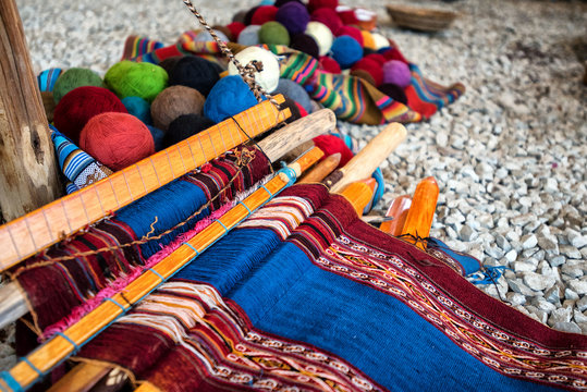 Traditional Quechuan alpaca weaving tools and balls of alpaca yarn