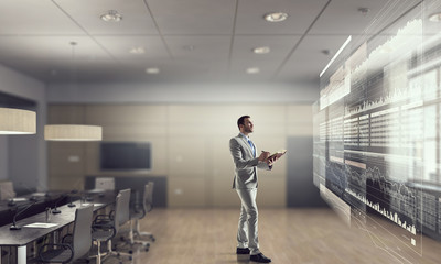 Fototapeta premium Businessman in his office . Mixed media