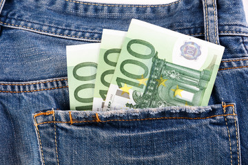 Banknotes hundred euro sticking out of the back jeans pocket.
