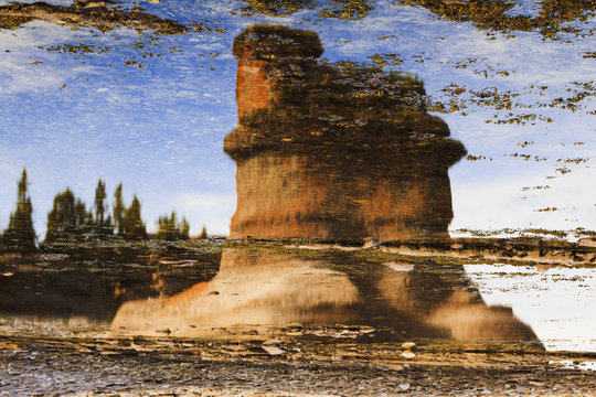 Monolith reflection at Anse des Bonnes Femmes at Ile Niapiskau, Mingan Archipelago National Park Reserve of Canada, Cote-Nord, Duplessis region; Quebec, Canada