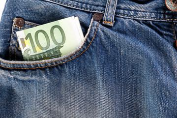 Banknotes hundred euro sticking out of the fore jeans pocket.