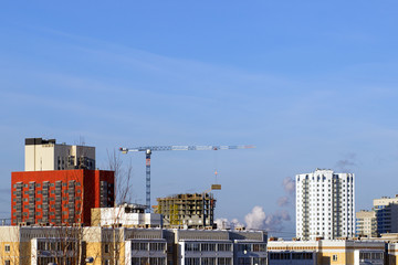 Tower cranes on a background of urban development