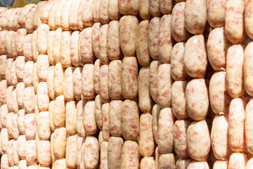 Sausage is hung on the railing to prepare grilled.