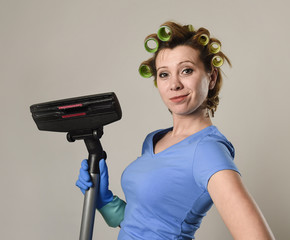 housewife with hair rollers and gloves happy smiling cheerful holding vacuum cleaner