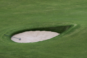 Golf club in a sand trap on a golf course; Maidens, Ayrshire, Scotland