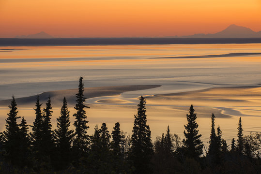 Mudflats at low tide and sunset, with Mt. Iliamna and Mt. Redoubt on the horizon, Turnagain Arm, Southcentral Alaska